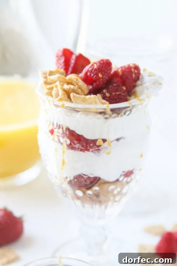 Delicious and healthy Cinnamon Berry Crisp Yogurt Parfait layered with Mom's Best Cereal, fresh berries, and creamy Greek yogurt for a perfect breakfast mashup.