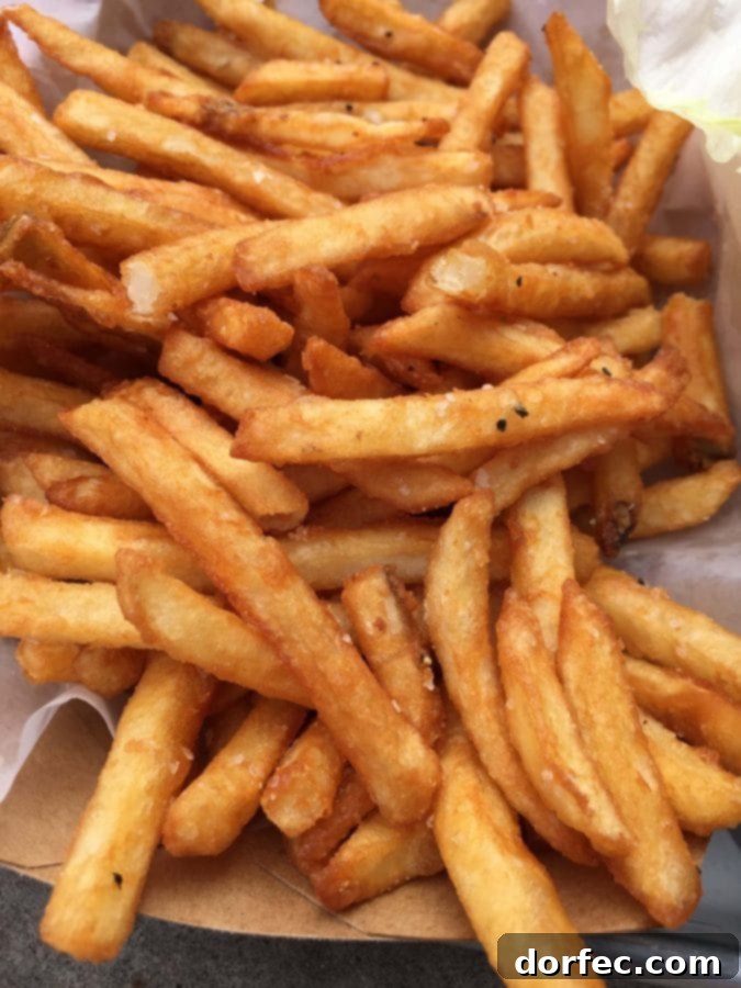 Close-up of crispy, perfectly golden French fries from Tilt, a must-try in Portland.