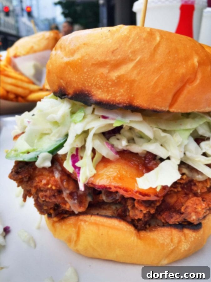 The famous 'Mother Clucker' fried chicken sandwich from Tilt, bursting with flavor and toppings.