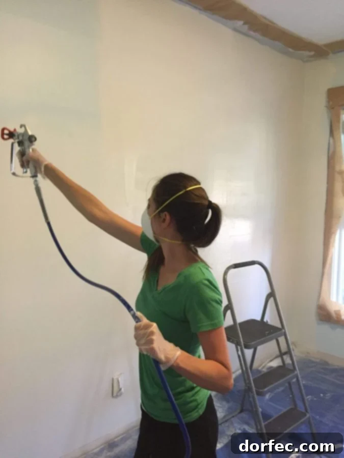 Preparing the front room walls for painting during the home office renovation project.