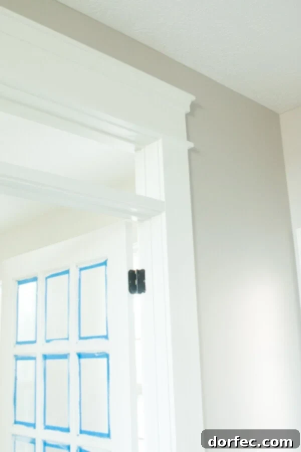 Details of the transom window above French doors, maximizing natural light and visual height.