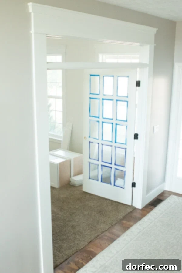 Custom built-in cabinets from MasterBrand Cabinets, providing ample storage and a clean aesthetic in the new office.