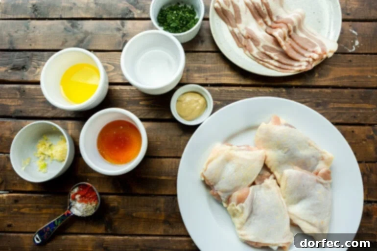 A photo of all the individual ingredients neatly arranged in separate small bowls, showcasing the simplicity and freshness for this honey mustard bacon chicken recipe.