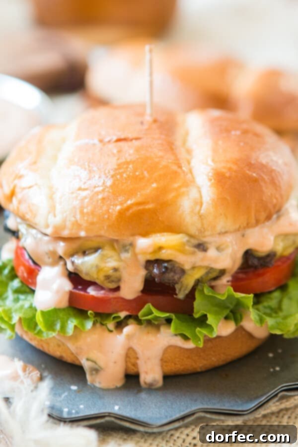 This is it, the killer burger sauce recipe. If you don't want dry, stale burgers look no further for the best classic hamburger sauce. A side view of a gloriously juicy cheeseburger, featuring crispy lettuce, ripe tomato, and our creamy burger sauce generously oozing from the sides.