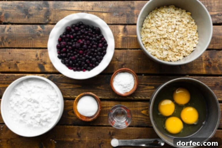 A vibrant flat lay photo showcasing all the fresh ingredients for healthy wild blueberry cottage cheese pancakes, neatly arranged in separate bowls on a rustic wooden table.
