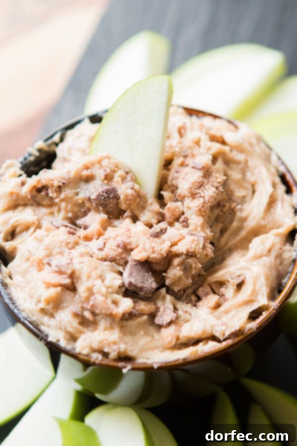 A stack of golden brown sugar and crunchy milk chocolate toffee bits, ingredients crucial for making a delicious toffee apple dip, sitting alongside a bowl of the finished creamy dip.