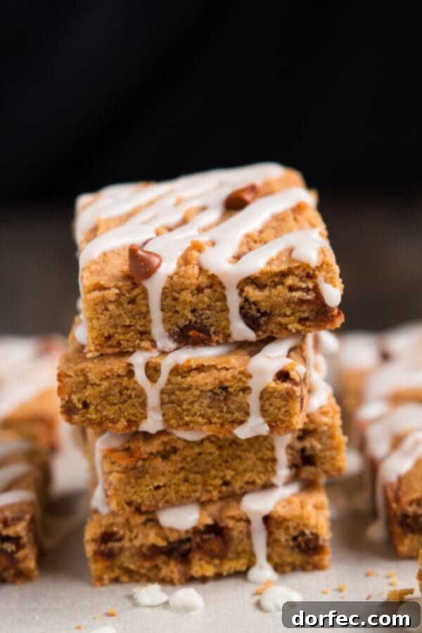 Deliciously chewy Cinnamon Pumpkin Cookie Bars with a drizzle of sweet icing, ready to be enjoyed during fall