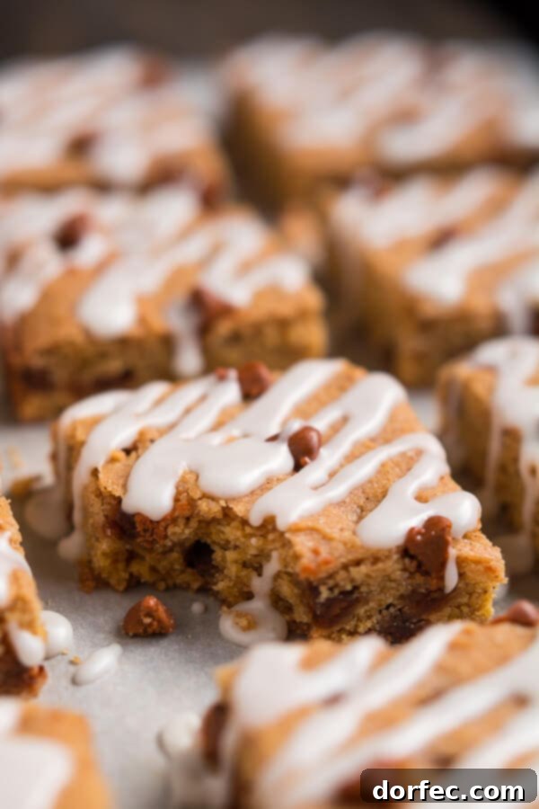 A baking sheet filled with warm, golden-brown Cinnamon Pumpkin Cookie Bars fresh from the oven