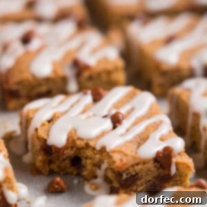 A freshly baked Cinnamon Pumpkin Cookie Bar with icing, ready to be served