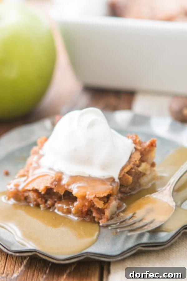 A slice of Apple Cake with Caramel Sauce, ready to be enjoyed