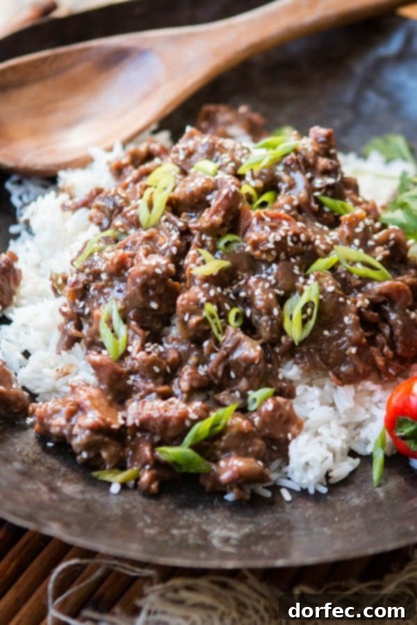 Close-up of tender Slow Cooker Korean BBQ Beef, showcasing its rich, caramelized sauce and juicy texture.
