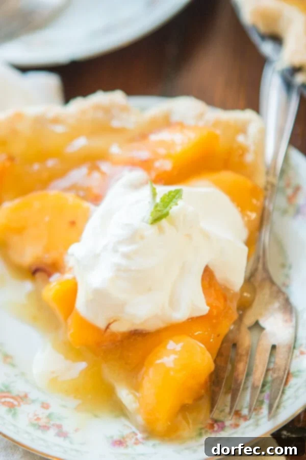Ready-to-Serve Peach Pie Sliced lemon jello peach pie, showing the vibrant peach and lemon filling with whipped cream.