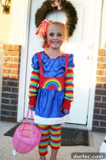 Kids holding Trick or Treat bags, posing in their Halloween costumes.