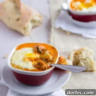 Perfectly baked eggs in tomato sauce with crispy bread for dipping