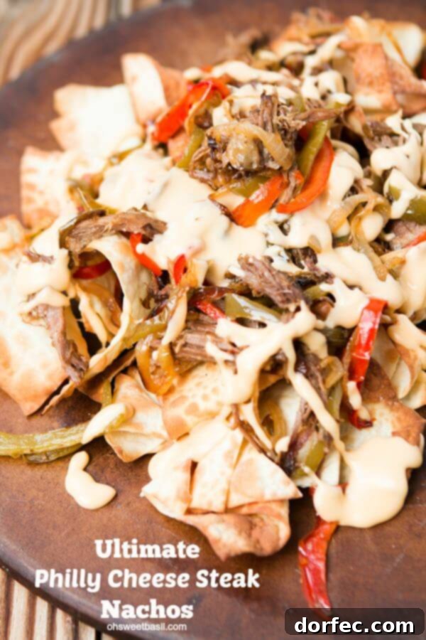 The ultimate Philly Cheese Steak Nachos, featuring steak, cheese, and peppers on crispy chips, an amazing twist on a classic.