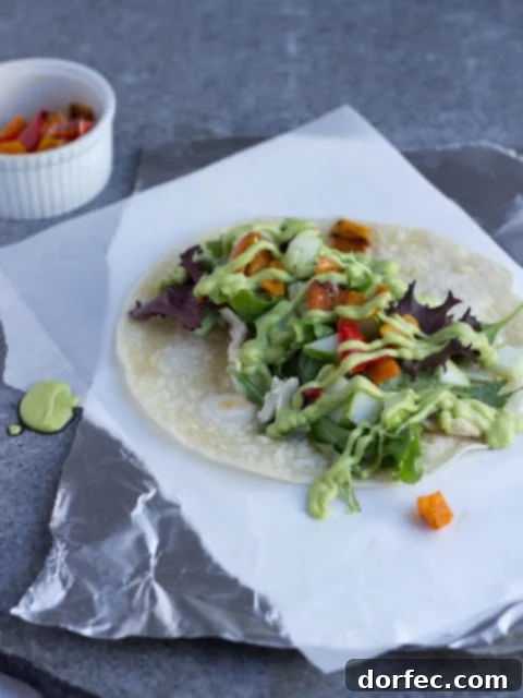 Ingredients for a Honey Avocado Wrap: mixed greens, sliced cucumbers, sauteed peppers, shredded chicken, and a bowl of the creamy honey avocado dressing.