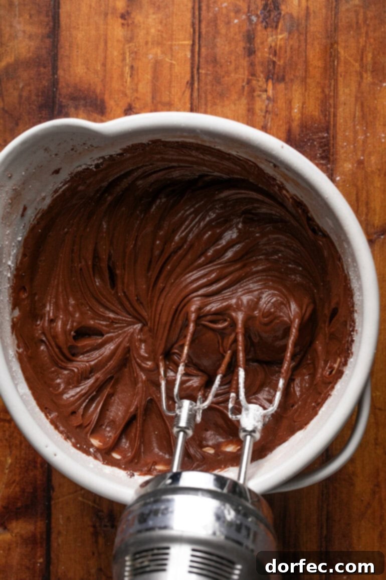 A visual guide showcasing the essential steps for preparing smooth and luscious chocolate cream cheese frosting, from creaming butter and cream cheese to achieving the perfect spreadable consistency.