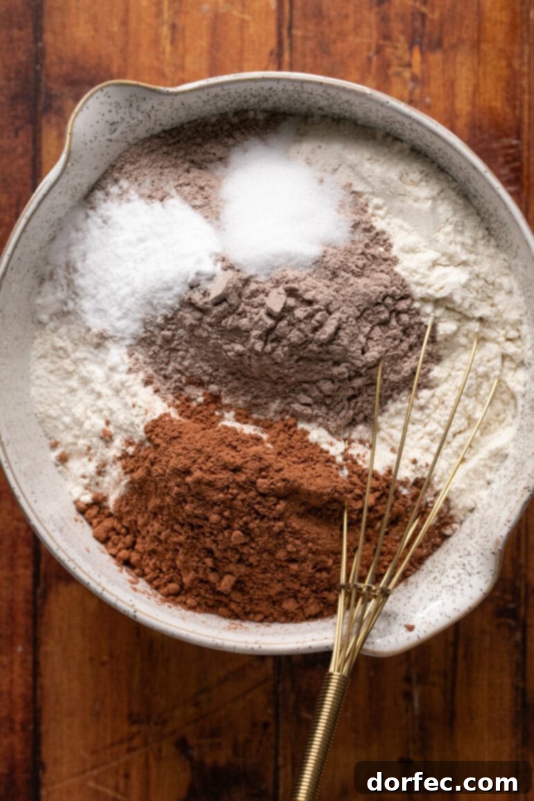 The wet ingredients, including butter, sugars, and eggs, thoroughly combined and appearing light and fluffy in a mixing bowl, demonstrating the correct consistency before adding dry ingredients.