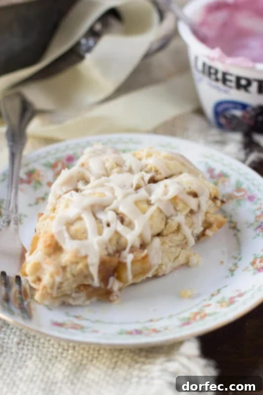 Delicious Brown Butter Apple Pie Scones with a sweet glaze, perfect for a treat. ohsweetbasil.com
