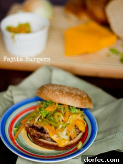 Sizzling Mexican Fajita Burgers 10 A top-down view of a generously topped fajita burger, ready for a delicious bite, highlighting the colorful ingredients.