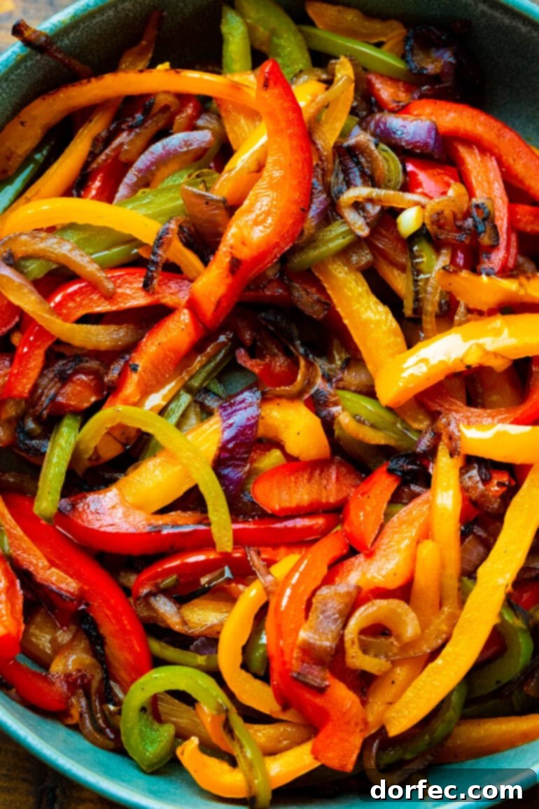 Sizzling Mexican Fajita Burgers 5 A close-up photo of beautifully sautéed, colorful bell peppers and sweet onions, softened and slightly caramelized, ready to top a delicious fajita burger.