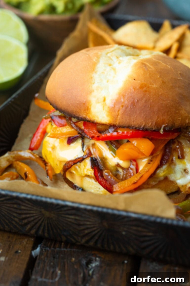 Sizzling Mexican Fajita Burgers 8 A delicious Mexican burger, artfully arranged and dripping with melted cheese and a creamy sauce, generously topped with sautéed peppers and onions for an irresistible appeal.