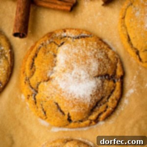 a photo of a soft and chewy molasses cookie topped with sugar and covers in those signature crinkles