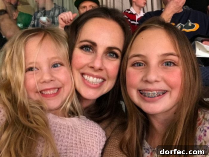 12 Precious Moments to Create With Your Daughter Before She's Grown 13 A heartwarming image of a mother embracing her two daughters, symbolizing love and connection.
