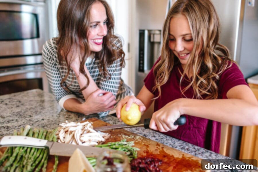 12 Precious Moments to Create With Your Daughter Before She's Grown 5 Mother and daughter joyfully cooking and preparing a recipe together in the kitchen.