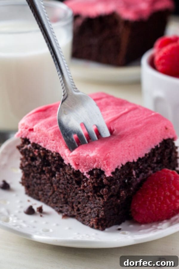 Strawberry Kissed Vanilla Dream Cake 6 A slice of rich, fudgy chocolate cake topped with pretty pink raspberry frosting.