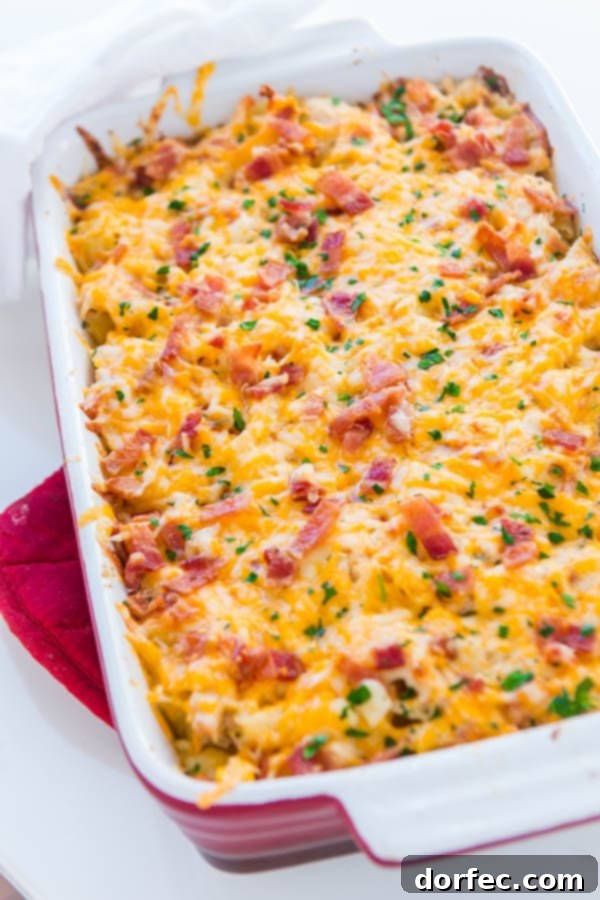 A delicious Cheesy Chicken Bacon Ranch Casserole, a perfect quick and easy dinner. Close-up of a rich and creamy Chicken Bacon Ranch Casserole in a vibrant red baking dish, ready to be served.