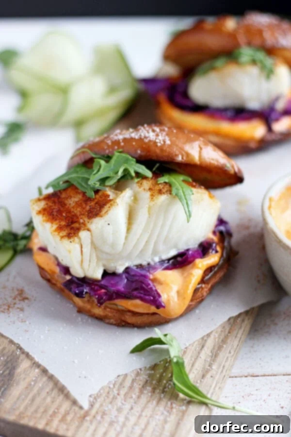 Quick Blackened Fish Burger with Sriracha Mayo Delicious and healthy blackened fish burger with sriracha mayo served on a brioche bun with purple cabbage and arugula.