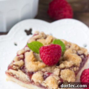 These raspberry crumble bars have a delicious shortbread base, a layer of juicy raspberries, and crunchy crumble topping. Delicious with ice cream, or a drizzle of sweet vanilla glaze.