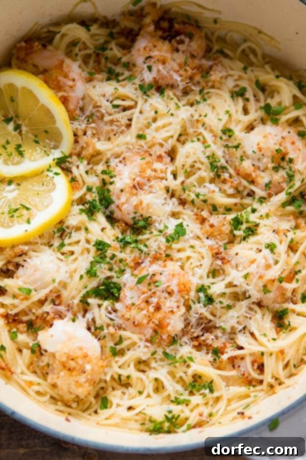 One Pot Crispy Parmesan Shrimp Scampi Pasta 2 A tantalizing close-up of One Pot Breaded Parmesan Shrimp Scampi Pasta, showcasing crispy shrimp and glistening sauce over spaghetti.