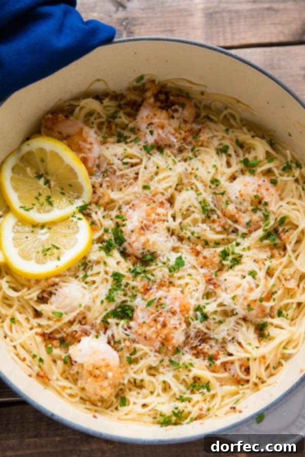 One Pot Crispy Parmesan Shrimp Scampi Pasta 5 A large Le Creuset saucier pot brimming with the finished One Pot Breaded Parmesan Shrimp Scampi Pasta, ready to be dished out.
