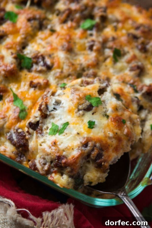 Hearty and flavorful cheesy hash brown sausage breakfast casserole, easy to prepare. serving up a portion of cheesy hash brown sausage breakfast casserole, showing its layers
