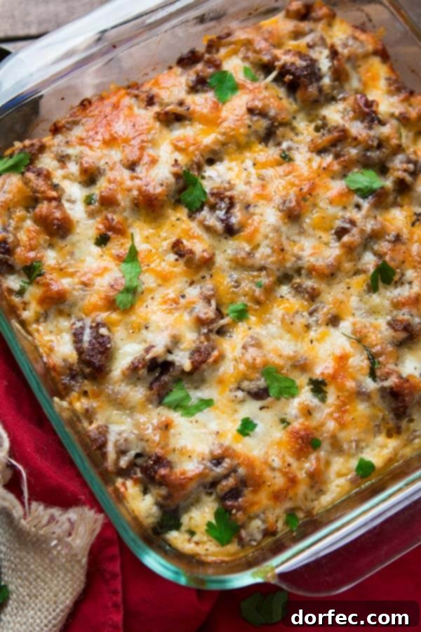 Baked to perfection: a cheesy hash brown sausage breakfast casserole. cheesy hash brown sausage breakfast casserole in square glass baking dish, freshly baked
