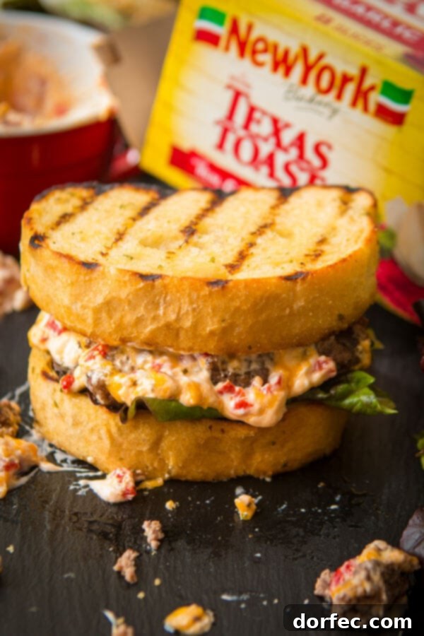 Another mouth-watering view of the Southern Pimento Cheeseburger, showcasing the layers of juicy burger, pimento cheese, and perfectly toasted Texas Toast.