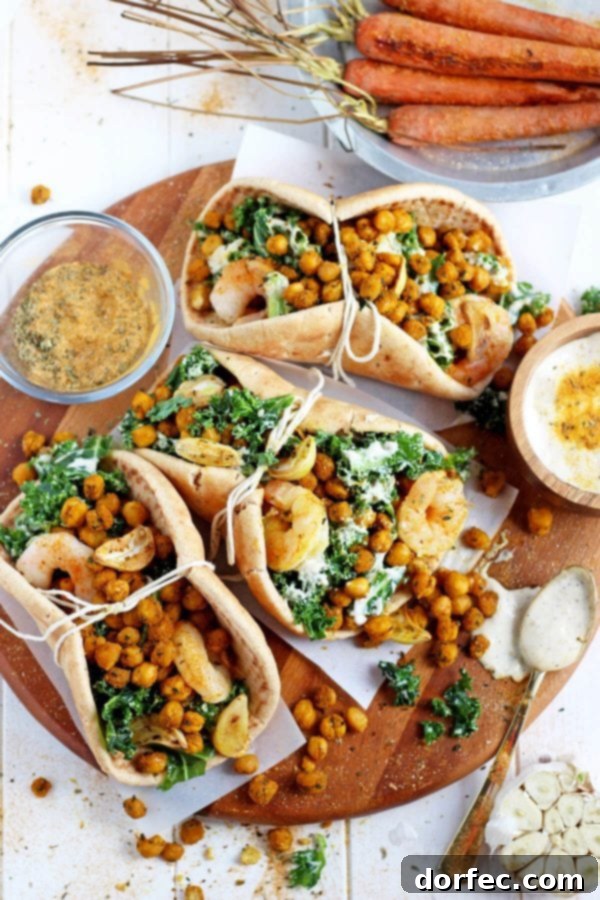 Serving Ideas for Healthy Roasted Chickpea Pitas Three roasted chickpea and garlic caesar salad pitas on a serving board.
