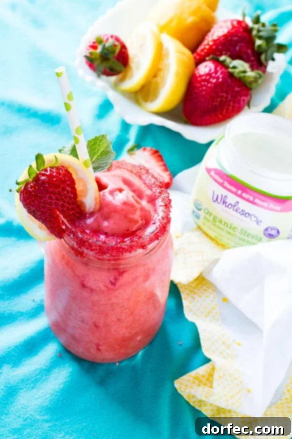 Wholesome Organic Stevia Frozen Strawberry Lemonade for Healthy Choices Four glasses of vibrant frozen strawberry lemonade arranged beautifully on a rustic wooden surface, with whole lemons and fresh strawberries scattered around, hinting at natural ingredients.