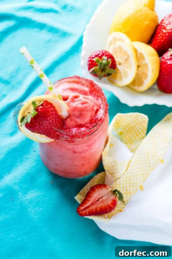 Simple Blender Recipe: Frozen Strawberry Lemonade A person pouring the smooth, thick frozen strawberry lemonade from a blender into a tall glass, emphasizing the ease of preparation.