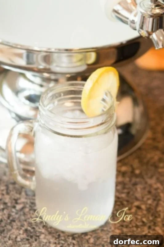 2-Minute Frozen Strawberry Lemonade 4 A frosty glass of Lindy's Lemon Ice, a non-alcoholic refreshing drink perfect for parties and gatherings, with visible lemon slices and ice.