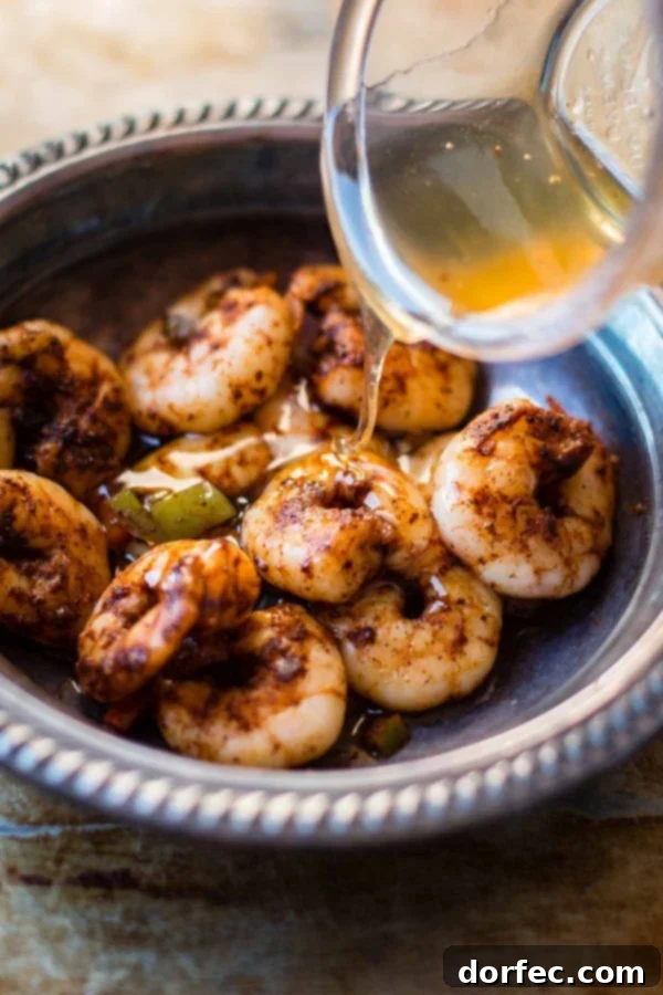 Delicious shrimp and peppers cooking in a single pan for an easy meal Close-up of succulent shrimp and bell peppers sizzling in a pan, part of a quick one-pot seafood dinner