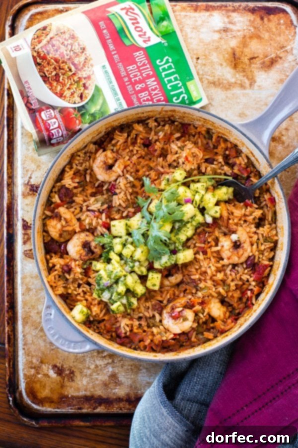 A colorful and delicious One Pot Sticky Honey Lime Shrimp meal Overhead shot of an assembled bowl of one-pot sticky honey lime shrimp and rice, garnished with fresh pineapple chimichurri