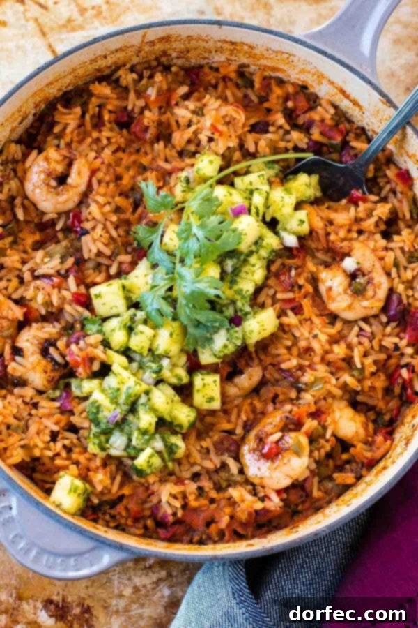 The vibrant heart of our one-pot shrimp and rice recipe A large skillet filled with a delicious one-pot meal, showcasing rustic Mexican rice, beans, and colorful vegetables