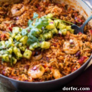 Sticky Honey-Lime Shrimp Skillet with Tropical Pineapple Chimichurri 2 A tantalizing close-up of one-pot sticky honey lime shrimp and rice, ready to be served