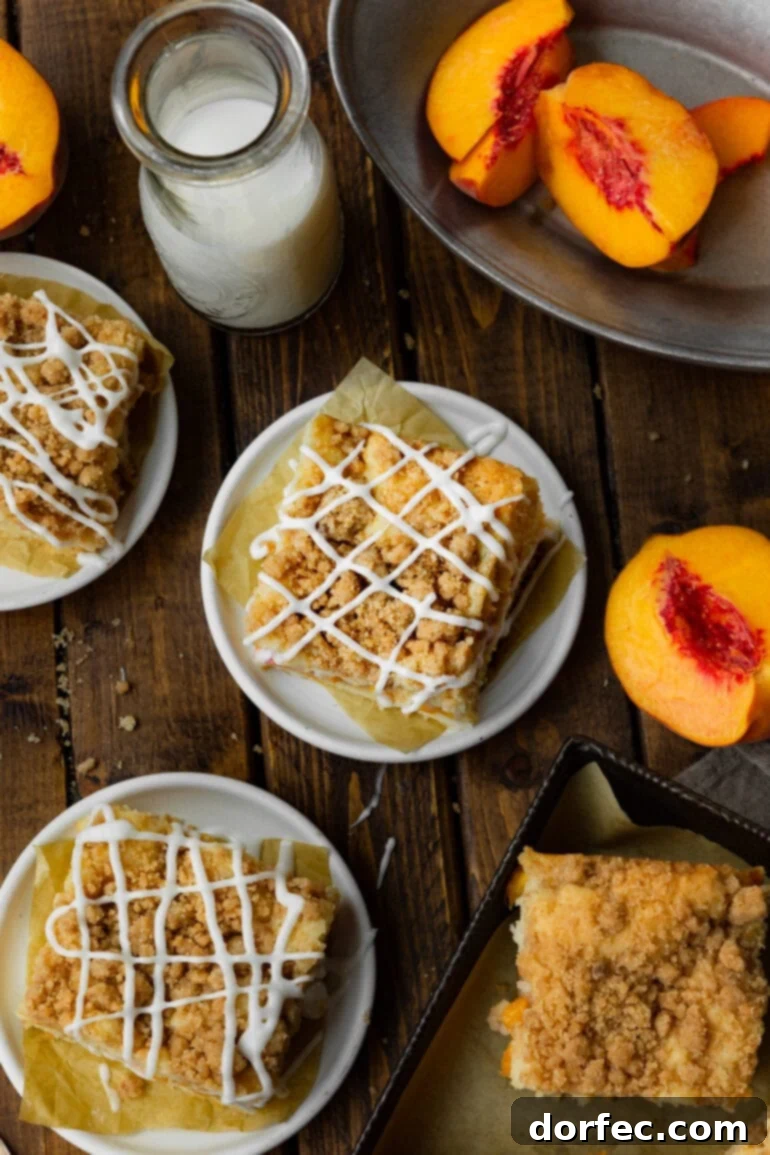Multiple servings of golden peach coffee cake, each perfectly topped with a cinnamon streusel and a delicate vanilla glaze, arranged invitingly.