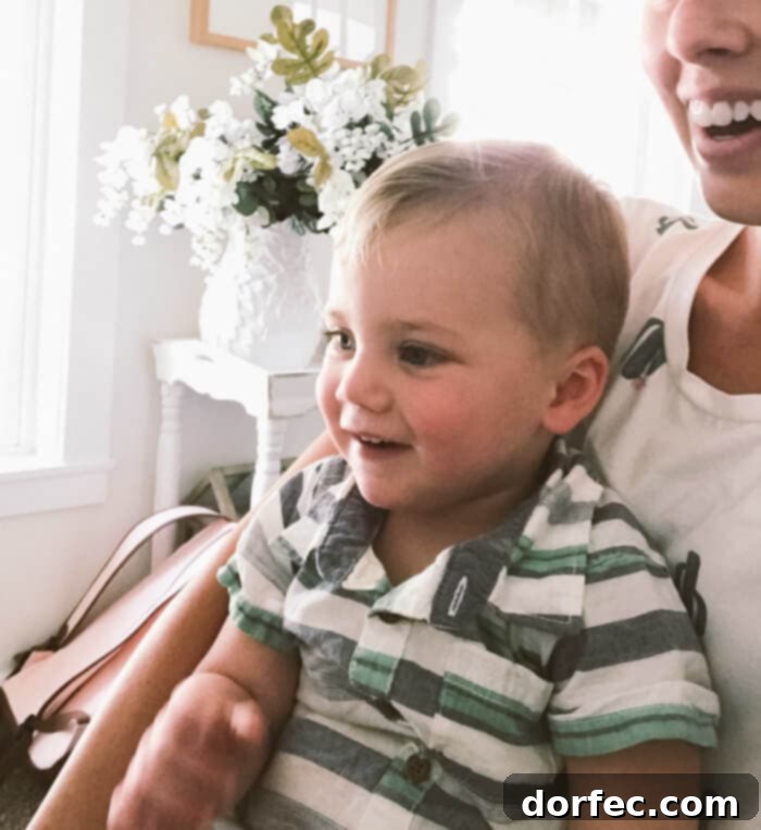 A toddler gleefully reacting to farm-to-glass milk videos during family home evening, creating joyful and educational moments.