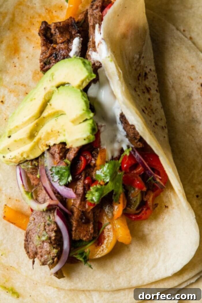 The Ultimate Steak Fajita Marinade 6 Close-up shot of a tender flank steak fajita strip, showcasing its juicy texture and rich seasoning.