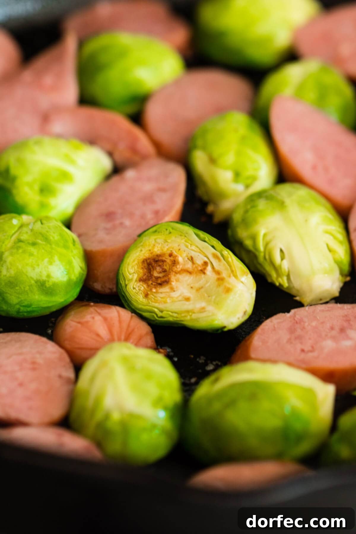 Achieve perfectly golden and crispy Brussels sprouts by cooking them in a savory bacon fat in a skillet.